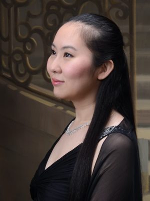 Sachie Ueshima, wearing black in front of a stone staircase.